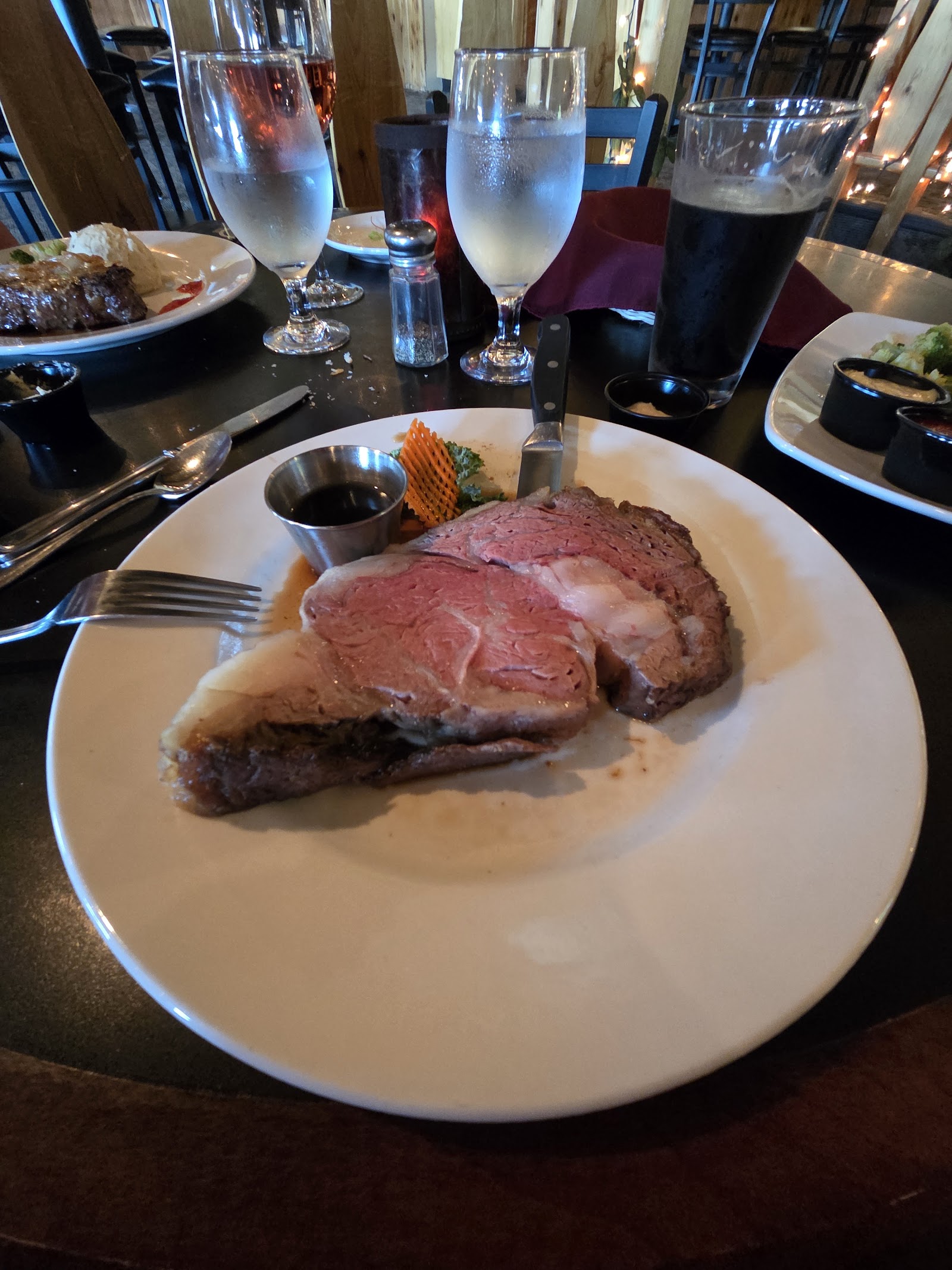 Sliced prime rib dinner served at Jagz Restaurant in Glacier National Park, with a small vegetable garnish.