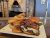 Juicy bacon cheeseburger with melted cheese and crispy onion rings at a Yellowstone National Park dining spot.