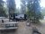 Grant Village Campground at Yellowstone National Park with an RV, trees, and a weathered picnic table.
