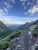 Highline Trailhead overlook along Glacier National Park's rugged ridgeline with wildflowers and distant peaks.