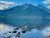 Lake McDonald, Glacier National Park, with clear blue water, rocky shoreline, and jagged mountain backdrop.