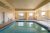 Indoor pool inside a lodge in Whitefish near Glacier National Park, with large windows and seating along the walls.