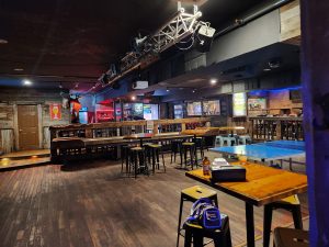 Bar area inside Glacier National Park lodge, timber walls and rustic seating create a warm, social atmosphere.