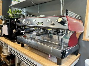 Red La Marzocco espresso machine anchors the cafe counter in Glacier National Park.