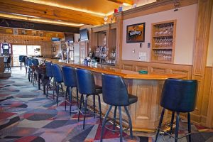 Exterior facade of a warm Italian steakhouse with a striped awning and welcoming entrance