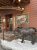 Entrance to a rustic lodge restaurant in Yellowstone National Park with a life-sized moose statue near the steps.