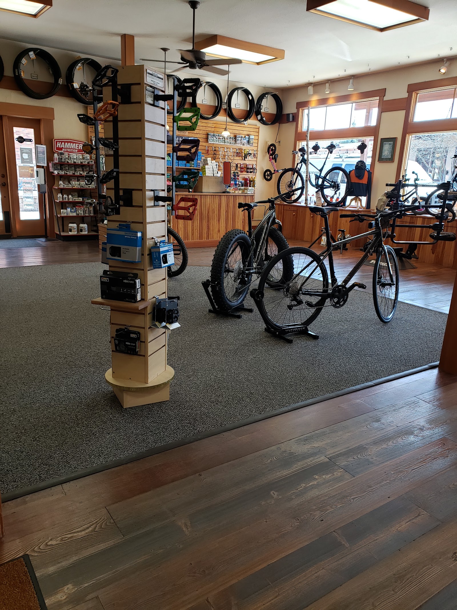 Bicycle shop interior at Glacier Cyclery & Nordic in Glacier National Park, with bikes on display and repair gear lining the walls.