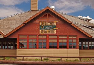 Rustic lodge exterior with timber framing and snowy surroundings