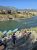 Rafts rest along the Yellowstone River as hikers descend toward the raft launch in Yellowstone National Park.