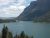 Saint Mary Lake at Glacier National Park surrounded by pine forests and towering peaks under a blue sky.