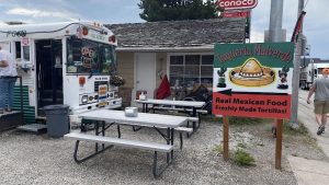 Colorful storefront with a striped awning and bold signage