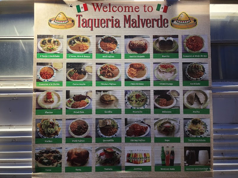 Colorful menu board with many dish photos and green labels, showing tacos and bowls, in Yellowstone National Park.