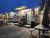 Food truck with open serving window and picnic tables in a gravel lot, Yellowstone National Park, winter evening.