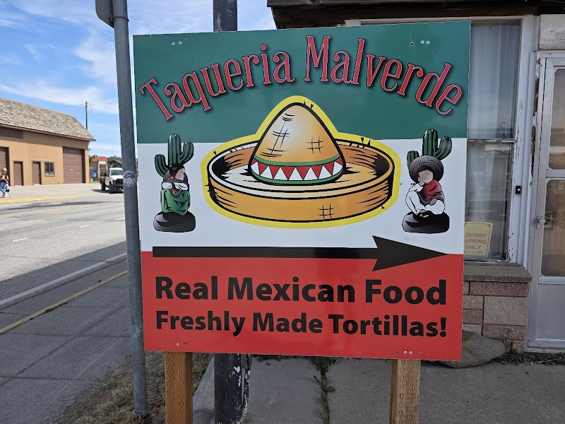 Colorful street sign advertising Mexican food and freshly made tortillas with a sombrero and cacti, Yellowstone Park.