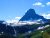 Going-To-The-Sun Mountain towers over snowfields in Glacier National Park, Montana.