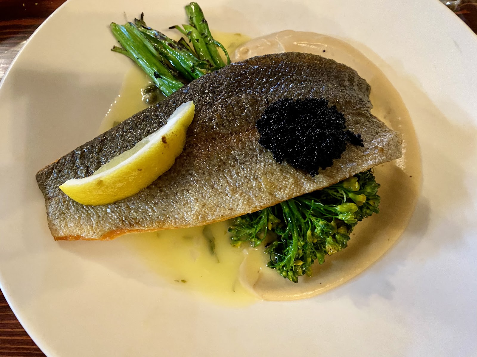 Pan-seared trout with lemon in Glacier National Park dining room setting.