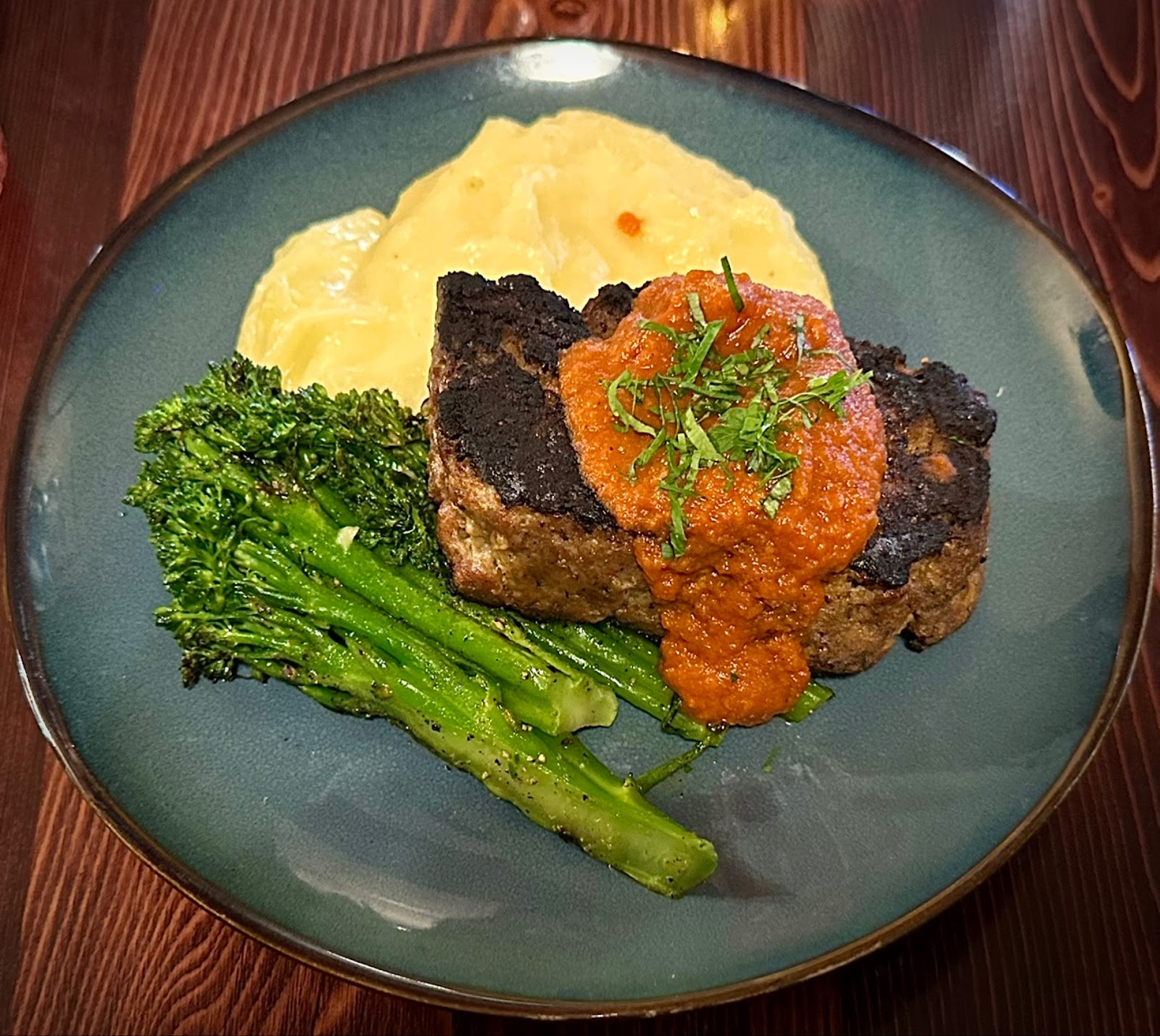 Dinner plate in Glacier National Park dining room featuring meatloaf with tomato sauce, mashed potatoes, and steamed broccoli.