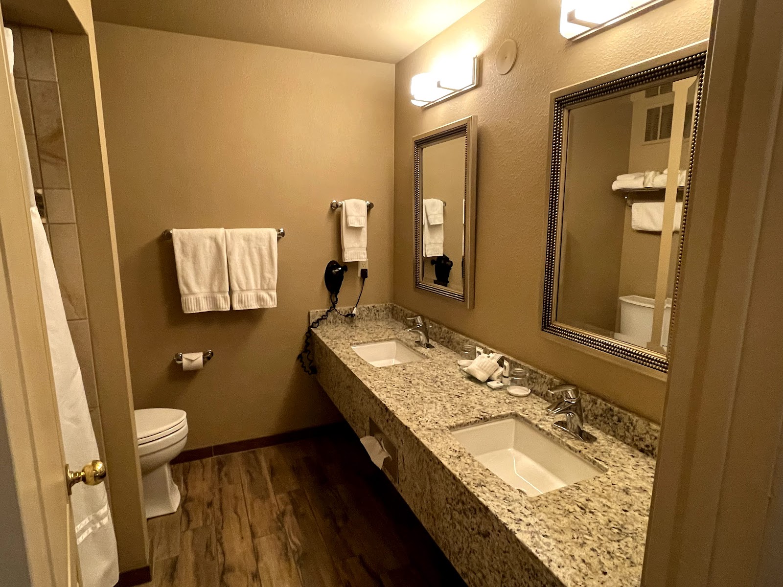 Glacier National Park lodging bathroom with a granite double-sink vanity and two mirrors.