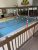 Indoor pool area at a Glacier National Park lodging facility, with red caution tape across the pool deck.