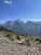 Rainbow Peak towers above a rocky overlook in Glacier National Park, showcasing rugged alpine scenery.