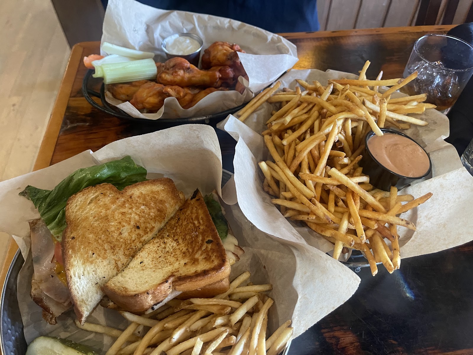 Grilled sandwich with lettuce and melted cheese and a side of fries at a Glacier National Park restaurant.