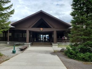 Grant Visitor Center at Yellowstone National Park with a wooden entrance and surrounding pines.