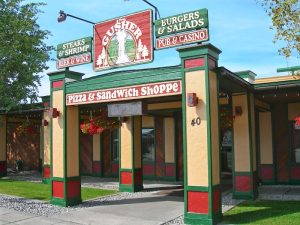 Pizza and sandwich shoppe storefront with bold sign and striped awning