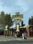 The Gusher restaurant sign and facade along a Yellowstone National Park road, advertising pizza and sandwiches.