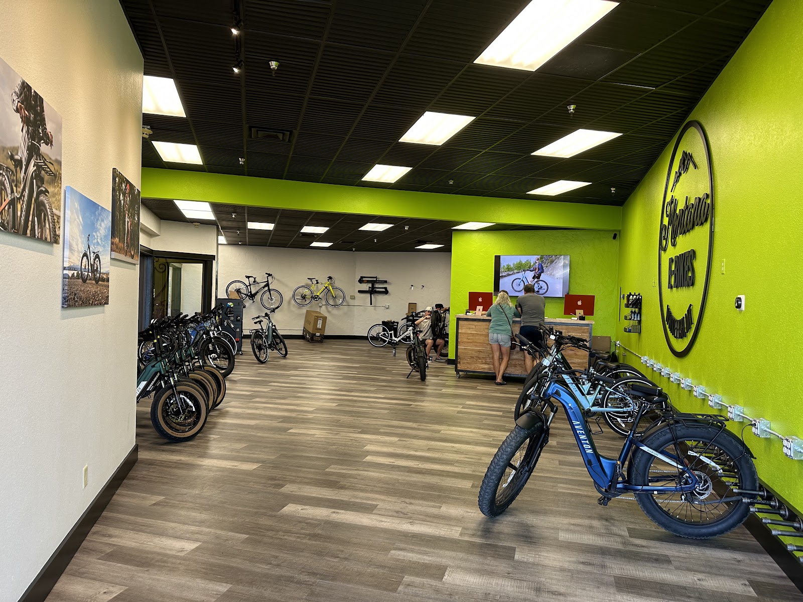 Inside Glacier National Park, a gift shop displays e-bikes and accessories near a bright lime-green wall.