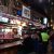 Interior of a rustic glacier national park saloon bar with patrons and bottles on the counter.