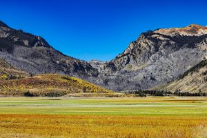 Exterior view of a rustic trailhead entrance with wooden signage and natural surroundings