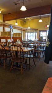 Storefront exterior with a pizza-themed sign and red awning