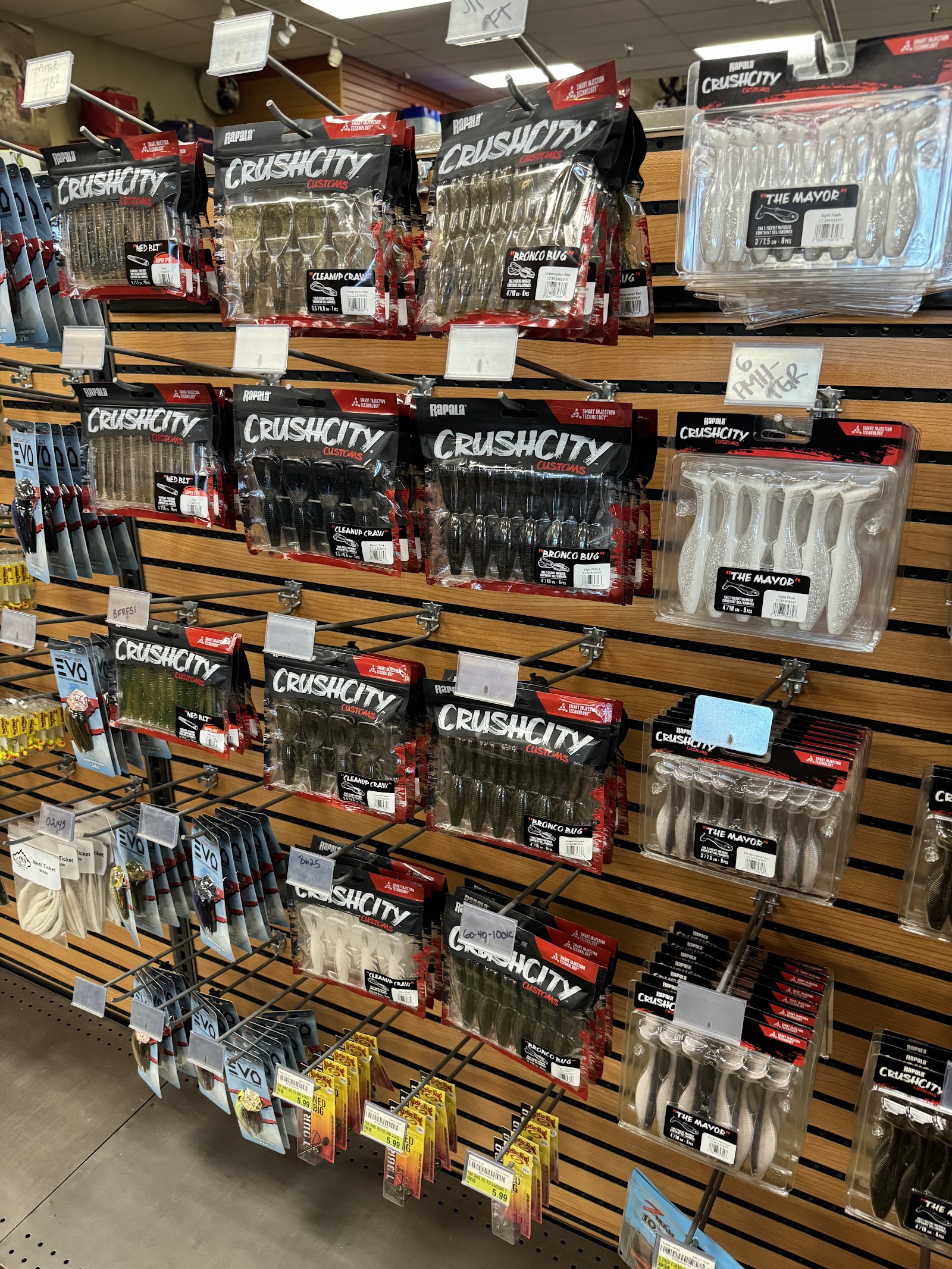 Glacier National Park gift shop display of CrushCity fishing lures and tackle products on hooks.