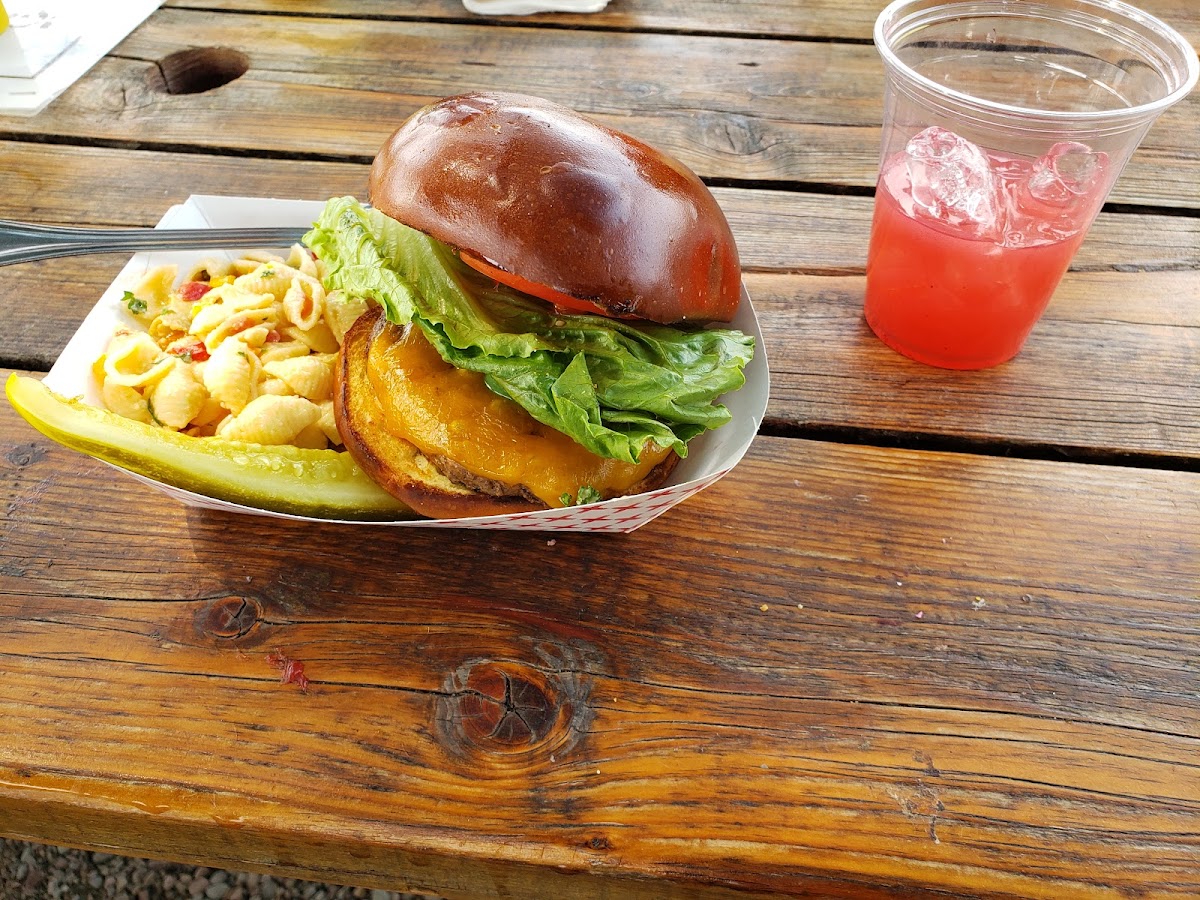 Burger meal at Northern Lights Saloon in Glacier National Park with greens and fries on a rustic table