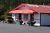 Campground office building with red roof and flower planters at Glacier Peaks RV Park & Campground, Glacier National Park.