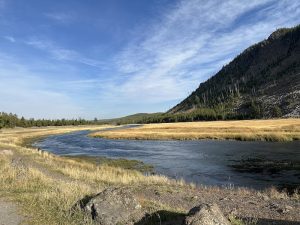 Wide exterior view of the trailhead entrance with sign and trail stairs