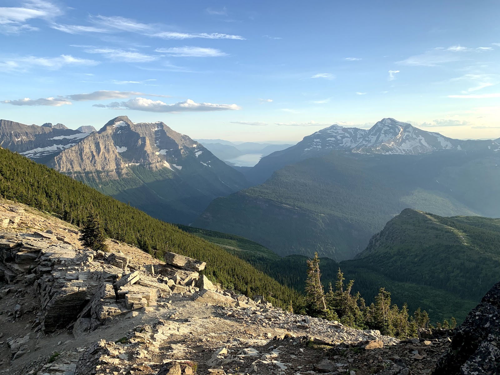 Grinnell Glacier Overlook in Glacier National Park reveals sweeping jagged peaks and alpine terrain with distant glacier remnants.