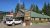Lodge-style dining lodge at Glacier National Park with a green metal roof, wood siding, and a prominent sign.