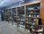 Inside a Glacier National Park gift shop, rows of hats line wooden shelves along corrugated metal walls.