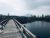 St. Mary Campground boardwalk in Glacier National Park crosses a calm river with snowcapped peaks in the distance.