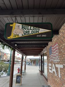 Saloon storefront sign in Glacier National Park’s gateway town, Montana, with rustic wood architecture.