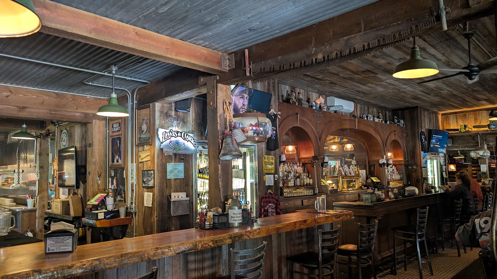 Rustic bar interior in Glacier National Park featuring wood beams and warm lighting.