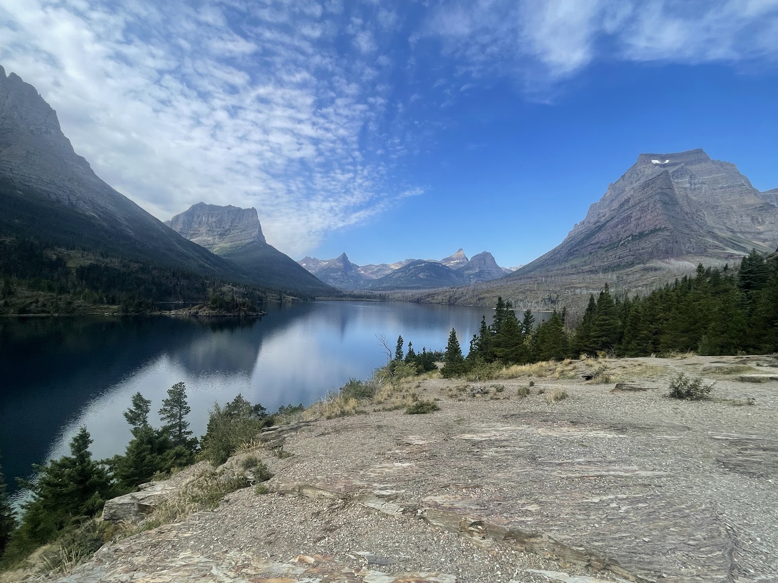 Apgar Campground overlooking a tranquil lake with towering Glacier peaks beyond in Glacier National Park.