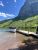 Two Medicine Lake at Glacier National Park features a boat by the dock with towering canyon walls nearby.