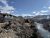 Lodging buildings line a river canyon with snow-capped mountains in Yellowstone National Park