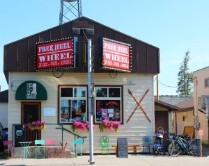 Exterior storefront with rustic awning and Freeheel and Wheel signage