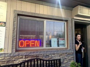 Cozy storefront with outdoor seating and warm lighting