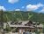 Base Lodge at Glacier National Park on Whitefish Mountain Resort, set among evergreen pines with a mountain backdrop.
