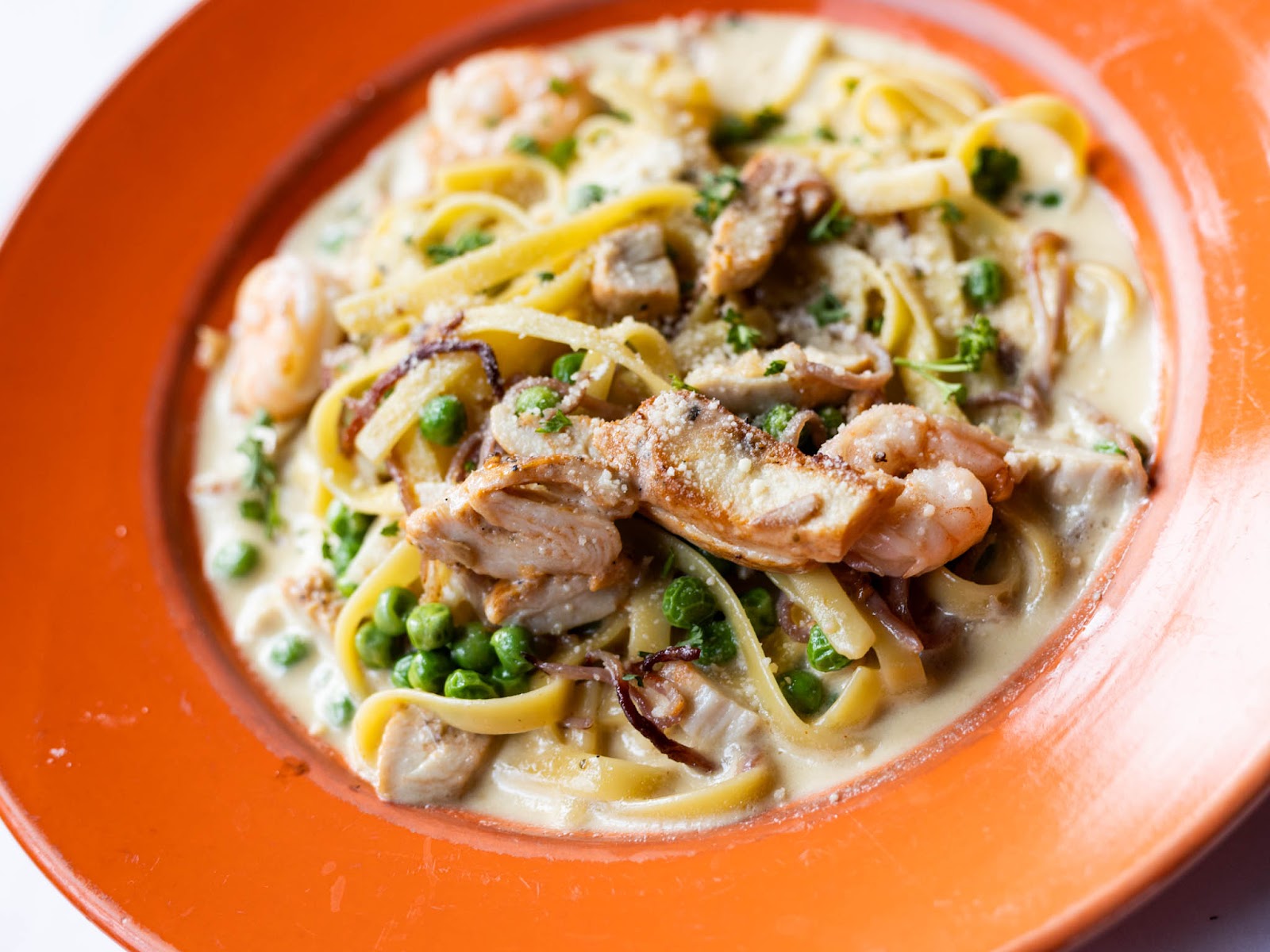 Creamy mountain Italian pasta with chicken, peas, and herbs served in Glacier National Park.