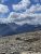 Rocky ridge overlook on Matahpi Peak in Glacier National Park, with jagged peaks and a bright blue sky.